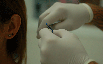 Shaping her ear piece..