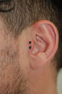 double black barbell tragus piercing